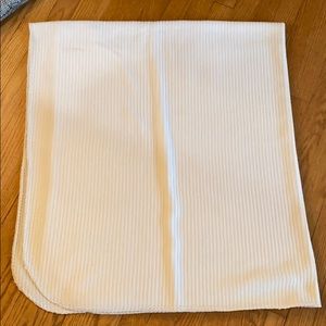 A white ribbed soft light blanket